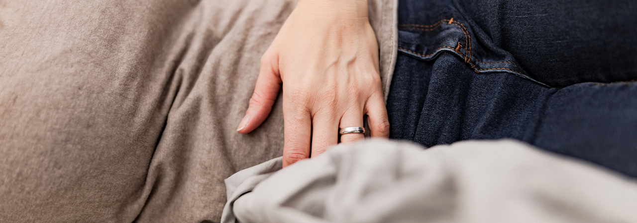 Image of a person experiencing pelvic pain, highlighting the affected pudendal nerve area.