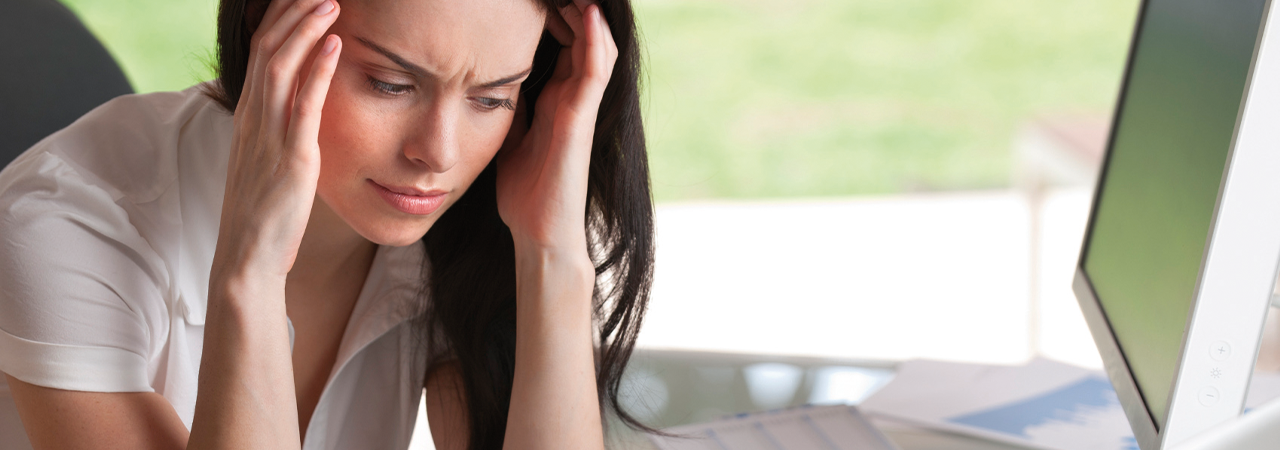 Women holding her head because of head aches